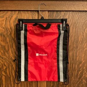 Microsoft red drawstring backpack with reflectors